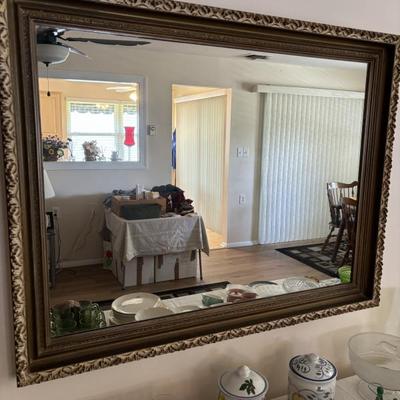 Very large, antique, rectangular beveled mirror, framed with a very heavy, ornate gilt frame.