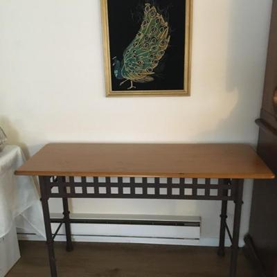 Heavy-duty entryway table w/ heavy metal base and natural wood top; above the table hangs a vintage framed beaded & sequined art...