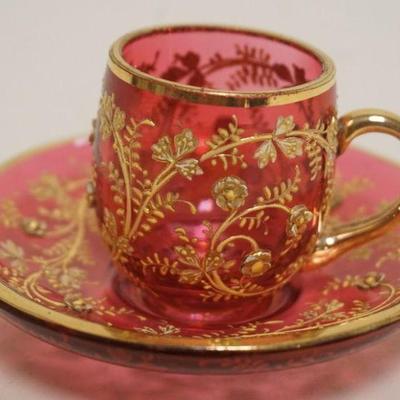 1134	VICTORIAN CRANBERRY GLASS DEMITASSE CUP & SAUCER W/RELIEF GILT VINE DECORATION, APPROXIMATELY 2 1/2 IN H
