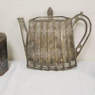 1169	SILVER PLATE GROUP, TEA CADDY, TEA POT TRIVET AND VASE, TRIVET APPROXIMATELY 8 IN X 8 IN 
