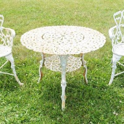 1236	CAST IRON GARDEN TABLE WITH 2 CHAIRS, HAVING A HEART SHAPED DESIGN, TABLE APPROXIMATELY 32 IN X 26 IN H
