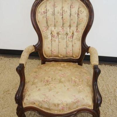 1211	CARVED WALNUT VICTORIAN ARM CHAIR WITH TUFTED BACK, APPROXIMATELY 43 IN H
