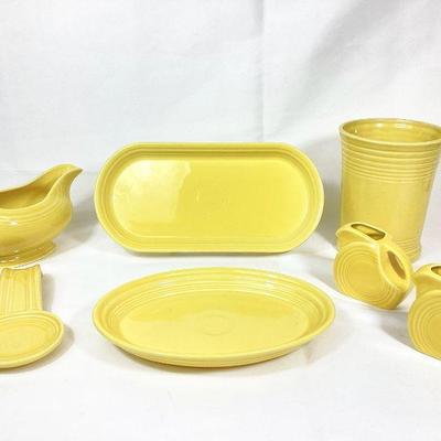 DILA712 Yellow Fiesta Ware Accessory Pieces	Seven Sunflower yellow pieces of Fiesta Ware. 
