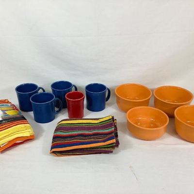 DILA702 Fiesta-ware Assortment	Collection of assorted fiesta-ware. Includes four orange fiesta-ware bowls, five fiesta-ware mugs, and an...