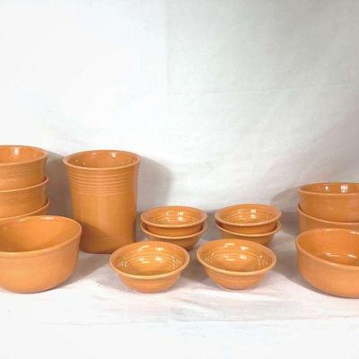 DILA706 Orange Fiestaware	Collection of orange fiesta ware. Includes 4 deep bowls, 3 regular bowls, 6 fruit bowls, and a large utensil...