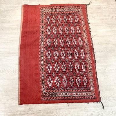 TOSH345 Handwoven Rug #3	This rug is more primitive as can be seen by the hand knotted threads on the back. Rug shows wear. It measures...