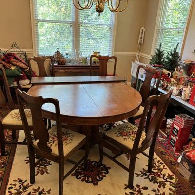 $650-table & chairs, 6 needle point chairs, one with arms, table- 30"H 54" diameter, one 12" leaf