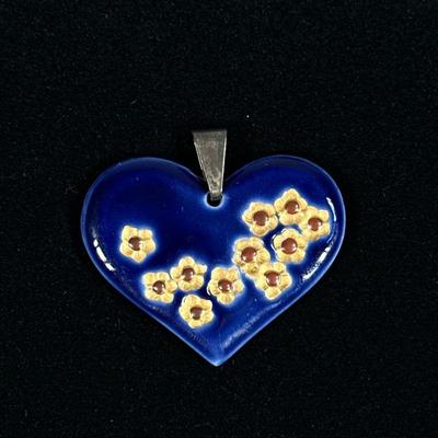 JENS WINDFELD HANSEN ROYAL COPENHAGEN HEART PENDANT | Porcelain blue heart-shaped pendant with gilt impressed flowers by Royal Copenhagen...
