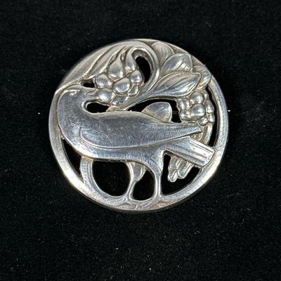 GEORG JENSEN STERLING BROOCH | Depicting bird with berries, marked on back “Georg Jensen / 925 S / DENMARK / 275” 15.8 g. - dia. 1.75 in

