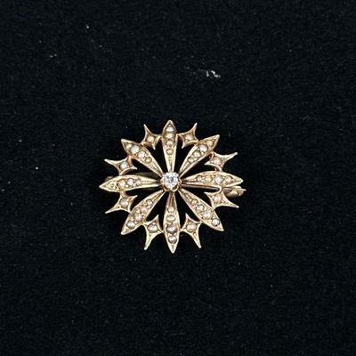 DIAMOND & 10K FLOWER PIN | Designed as a (tested to) 10K gold flower-form pin/brooch set with center diamond; 1 in., 3.6g. No...