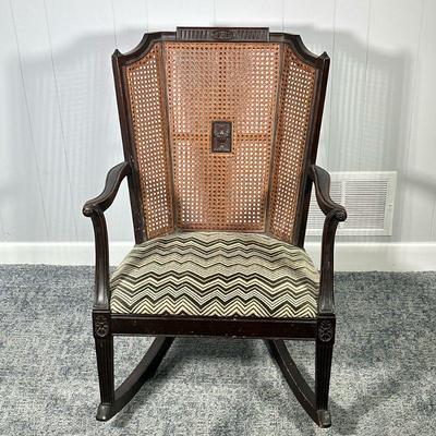 ANTIQUE WOOD ROCKER | Carved wood racking chair having caned back with center urn carving, curved arms leading to fluted legs over curved...