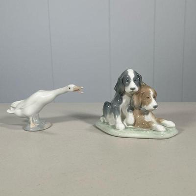 (2PC) LLADRO ANIMAL FIGURINES | Lladro porcelain animal figurines including pair of dogs and a goose. - l. 6 x w. 4.5 x h. 4. in

