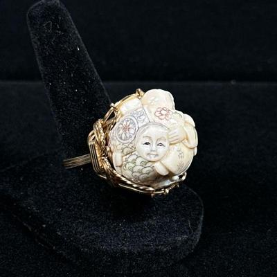 BONE & 10K GOLD RING | Carved bone ring with (tested to) 10K gold setting; 1.5 in., total weight: 13.4g. Ring size: 7.5 No apparent...