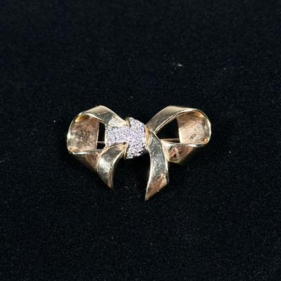 DIAMOND & 14K GOLD BOW PIN | Designed as a (tested to) 14K gold bow-form pin/brooch set with melee diamonds; 1.5 in., 8.7g. No...