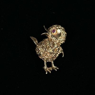 14K GOLD CHICK PIN | Designed as a 14K gold bird-form pin/brooch with pink sapphire eye, marked on back "14K"; 1.25 in., 10.2g.


