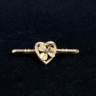 14K GOLD HEART PIN | Designed as a (tested to) 14K gold heart form with flower pin/brooch, 1.75in. 3.7g. No apparent markings.

