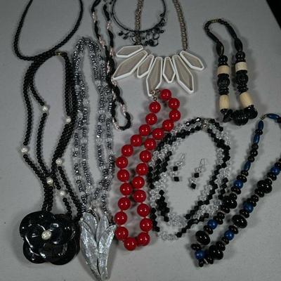 (13PC) LARGE ASSORTMENT OF COSTUME JEWELRY NECKLACES | Includes various costume jewelry necklaces with various carvings and beadwork...