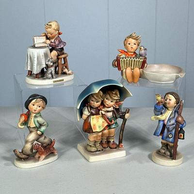 (5PC) ASSORTED HUMMEL FIGURINES | Including: Little Bookkeeper Hum 306, Hear Ye, Hear Ye Hum 15/0, Strolling Along Hum 5, Stormy Weather...