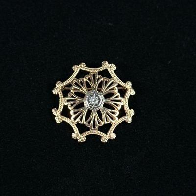 DIAMOND & 14K GOLD PIN | Designed as a (tested to) 14K octagonal gold pin/brooch set with single diamond in center; 1 in. 4.6 g. No...