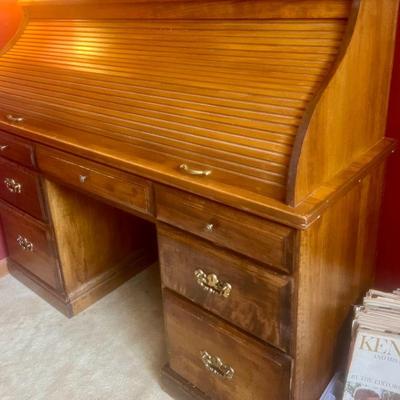 Solid wood roll top desk.