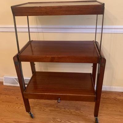 $299- Carta table, unique vintage piece, 3 tier shelves flip to a table, on casters 40"H 27"L 13"depth as shelves,...