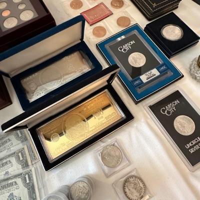 Silver bar, Gold clad silver bar, Carson City Morgan dollars. 