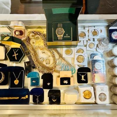 This really is an impressive gold case.  There are around 30 gold coins, 8 large diamond rings, Rolex, Nugget watches and bracelets,...