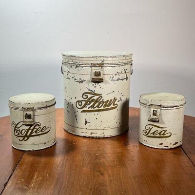 (3PC) KREAMER BRANDED TINS | Round flour, coffee, and tea canisters with hinged lids marked KREAMER on the bottom. - l. 9-1/2 x w. 9-1/2...