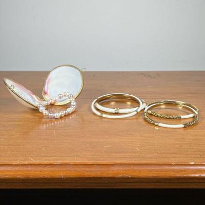 SEASHELL WITH PEARL BRACELET & BANGLE BRACELETS | Including 4 white and gold bangle bracelets, and a Seashell and pearl bracelet.

