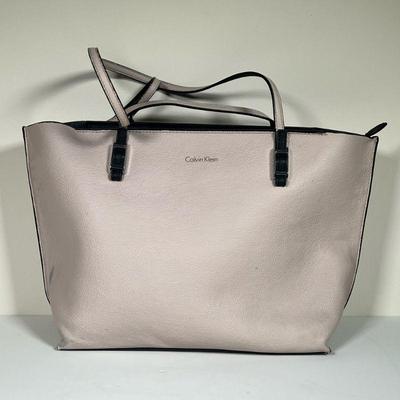 CALVIN KLEIN PURSE | Light pink leather Calvin Klien purse with black leather interior. - l. 17.5 x w. 5 x h. 11 in

