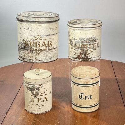 (4PC) VINTAGE KITCHEN CANISTERS | Round kitchen tins, including sugar, coffee, and two tea tins. - l. 8 x h. 8-1/2 in

