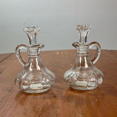 PAIR OF GLASS CRUETS | Two glass cruet jars. - l. 4 x w. 4 x h. 5 in

