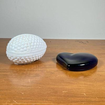 (2PC) TIFFANY & CO. GLASS PAPER WEIGHT | Blue glass heart paper weight by Tiffany & Co., and a white porcelain egg-shaped weaved...