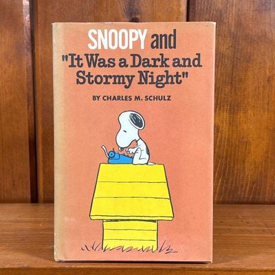 FIRST EDITION SNOOPY BY CHARLES M. SHULZ | Snoopy and "It Was a Dark and Stormy Night" by Charles M. Schulz, a hardcover book....