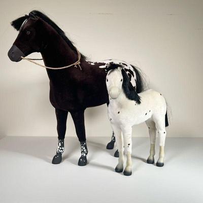 (2PC) AMERICAN GIRL DOLL HORSES | One black and white horse and a smaller white spotted horse, each marked on the hoof. - l. 21 x w. 6 x...