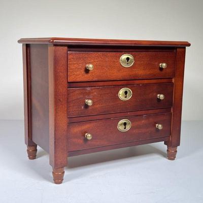 MINIATURE CHEST OF DRAWERS | Miniature salesman's sample dresser having 3 full-width drawers with lock and round brass pull, on...