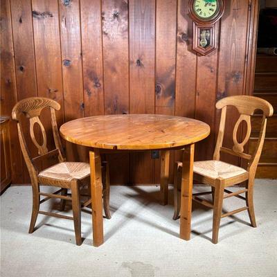 (3PC) TABLE & CHAIRS | Including a small round wood kitchen table and a pair of Pottery Barn "Napoleon" side chairs with...