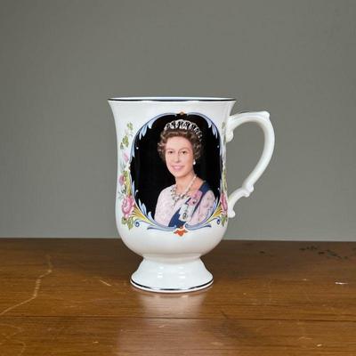QUEEN ELIZABETH II SILVER JUBILEE 1977 TALL MUG | Tall mug decorated with Queen Elizabeth II, a crown, silver edges, and commemorative...
