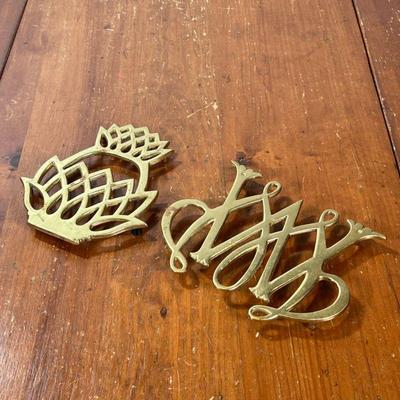 (2PC) BRASS TRIVETS | Including a Virginia Metal Crafters brass pineapple-form trivet and a vintage Williamsburg William & Mary...