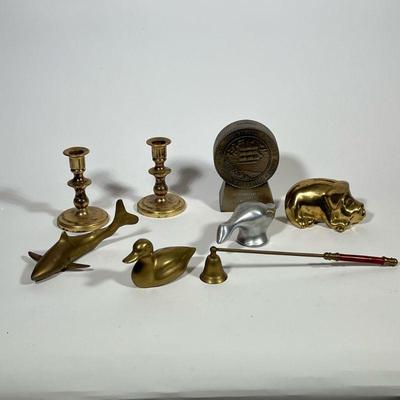 MISC BRASS LOT | Lot of decorative brass items including a pair of small candlesticks, a duck, shark, piggy bank, an aluminum figure, and...