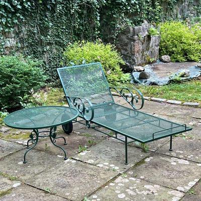(2PC) OUTDOOR PATIO LOUNGER & TABLE | Patio furniture set with curved wrought iron arms and leaf accents, including a lounge chair...