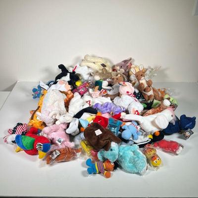 LOT OF BEANIE BABIES | A large collection of TY beanie babies, many with tags attached, including bears, rabbits, kangaroos, and other...