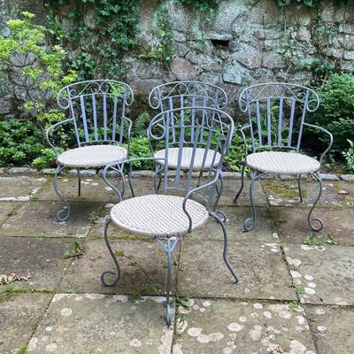 (4PC) IRON PATIO CHAIRS | Set of four outdoor patio armchairs with curved iron backs, woven seats, and curved wrought iron legs. - l. 22...