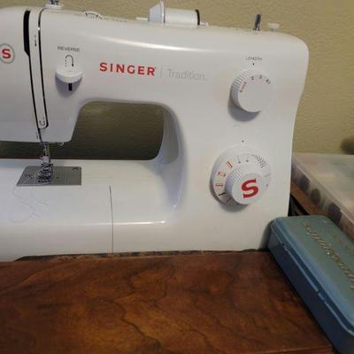 One of 2 Singer sewing machines (this one in cabinet)