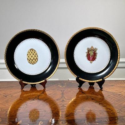(2PC) PAIR DECORATIVE PLATES | Having central gilt decorated urn/egg with black and gilt border. - dia. 10.75 in

