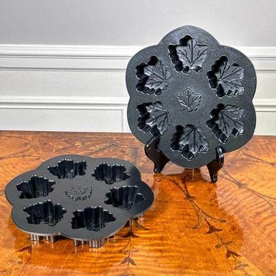 (2PC) PAIR NORDIC WARE MAPLE LEAF PANS | Pair of maple leaf cakelet pans by Nordic Ware, made in USA. - l. 10 x w. 9 x h. 1.25 in

