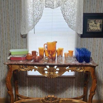 Modern marble top console table. 
Pyrex, carnival glass, Ohio oil carnival piggy bank and Libbey cobalt blue glasses. 