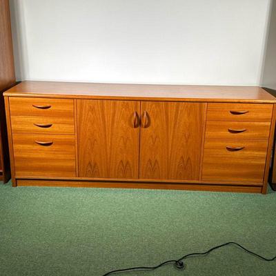 TEAK CABINET | Having 3 graduated drawers on either side with center 2 door 2 shelf cabinet with wood pulls. - l. 71.75 x w. 19.25 x h....