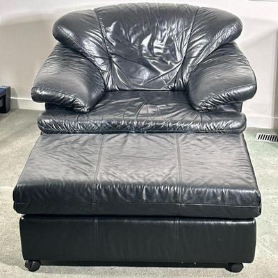 BLACK LEATHER ARMCHAIR & OTTOMAN | Black leather cushioned armchair with matching black leather ottoman on wheels. - l. 46 x w. 34 x...