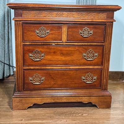 (2PC) PAIR WOOD NIGHTSTANDS | Pair of carved wood side tables having 3 drawers with brass pulls. - l. 26.25 x w. 17.25 x h. 26.5 in

